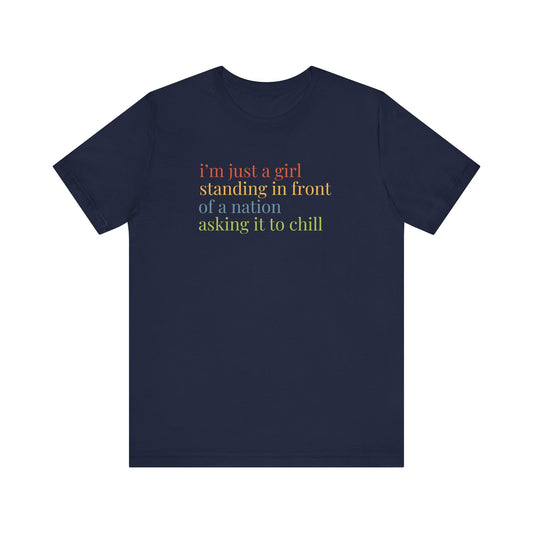 Navy blue t-shirt with colorful text "i'm just a girl, standing in front of a nation, asking it to chill"