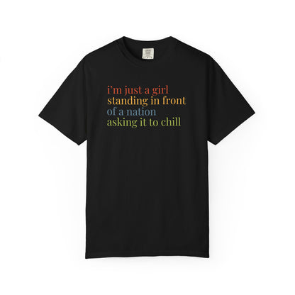 Black t-shirt with colorful text "i'm just a girl, standing in front of a nation, asking it to chill"