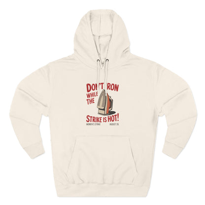 Beige hoodie with a retro iron graphic and "don't iron while the strike is hot" red text