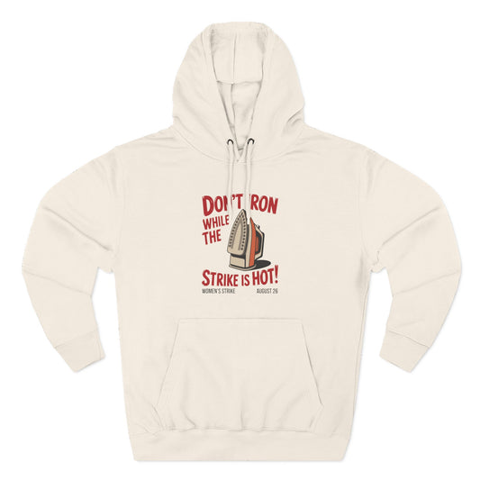 Beige hoodie with a retro iron graphic and "don't iron while the strike is hot" red text