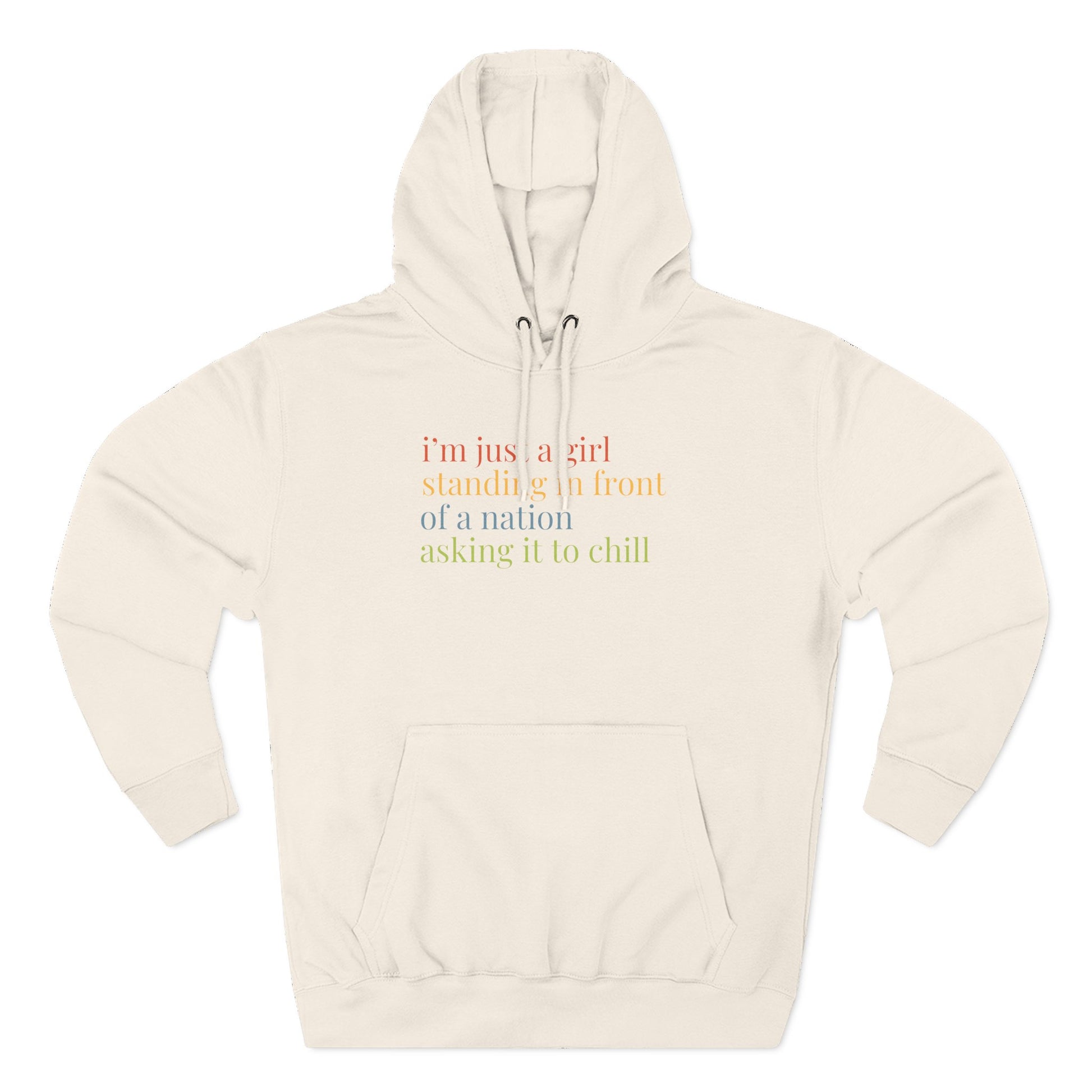 Beige hoodie with colorful text "i'm just a girl standing in front of a nation asking it to chill"