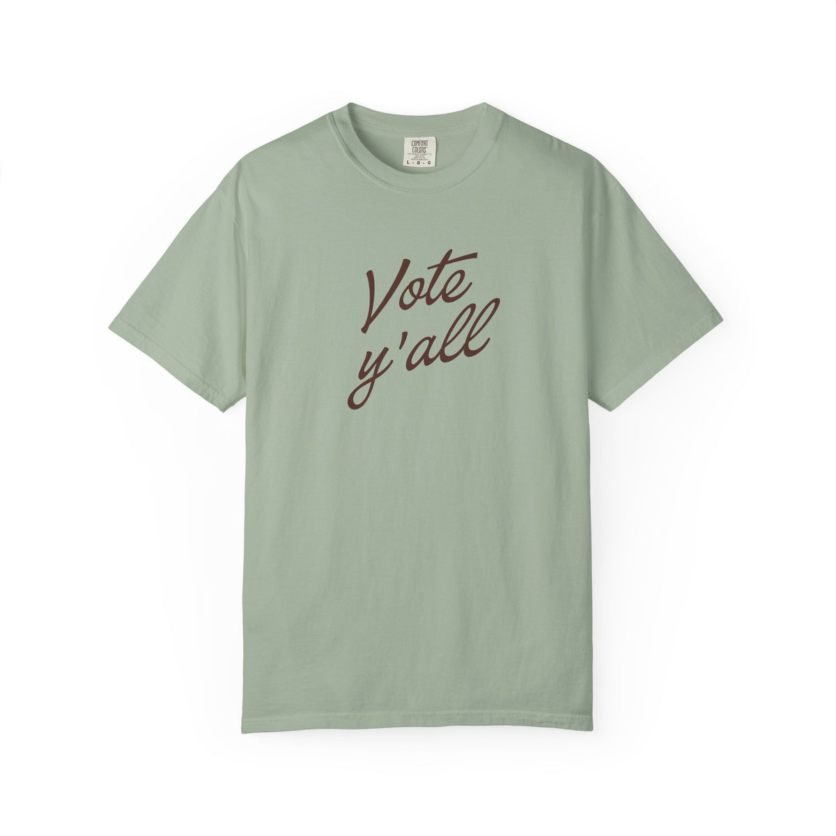 A short-sleeve crewneck t-shirt in a light green color, featuring the phrase 'Vote y'all' printed in brown cursive script across the chest, displayed on a clean white background.