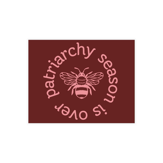 Maroon postcard with a pink queen bee illustration and pink text 'patriarchy season is over' 