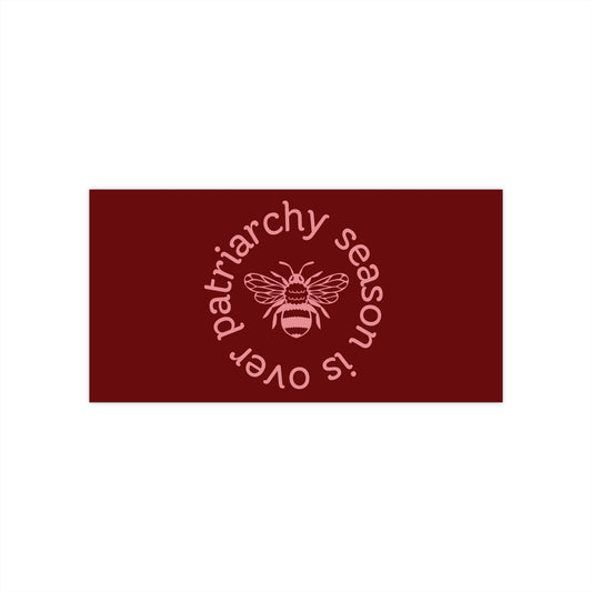 Maroon bumper sticker with pink queen bee graphic and pink text "patriarchy season is over" circling it