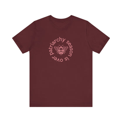 Maroon unisex t-shirt with 'Patriarchy season is over' dark pink text and bee graphic