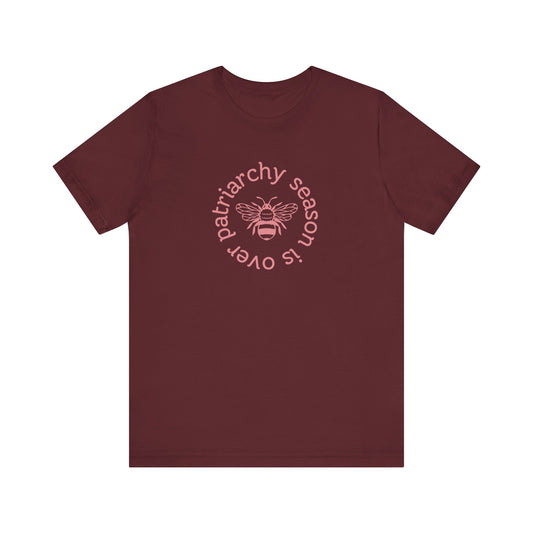 Maroon unisex t-shirt with 'Patriarchy season is over' dark pink text and bee graphic