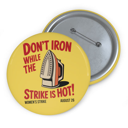 Yellow pin button with vintage iron graphic and text 'Don't Iron While the Strike is Hot!' red text