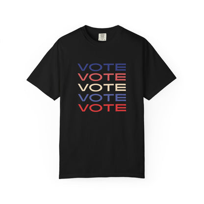 A black short-sleeve crewneck t-shirt featuring a stacked graphic print of the word 'VOTE' in blue, red, and beige, displayed on a clean white background.