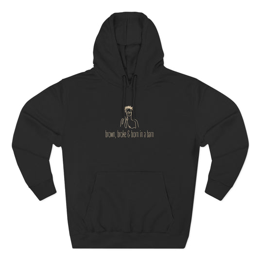 Black hoodie with sketch graphic of Jesus and cream text "brown, broke & born in a barn"