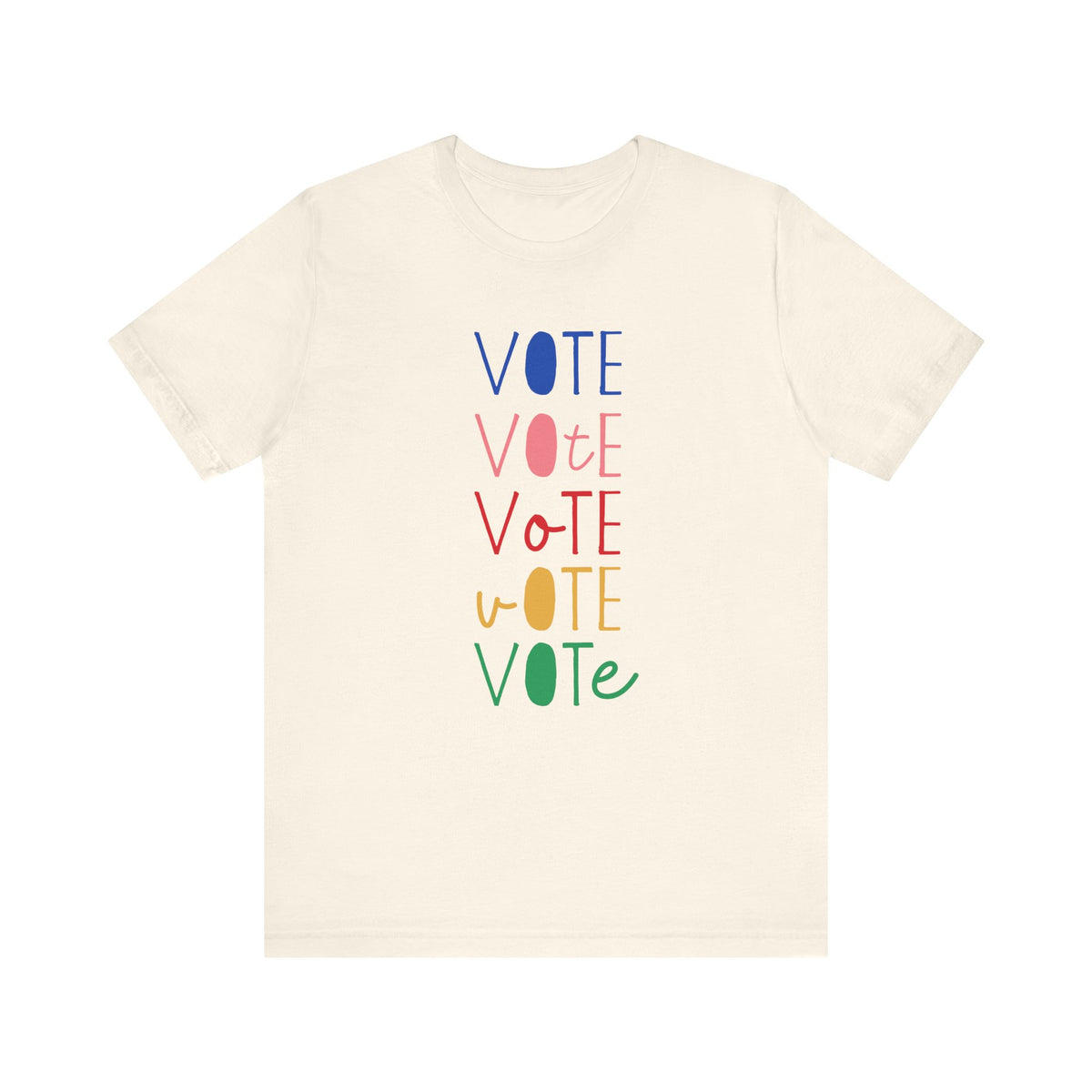 A cream short-sleeve t-shirt with a vertical graphic on the chest spelling 'VOTE' in alternating bright colors (blue, pink, red, yellow, green) with oval letterforms, shown on a plain white background.