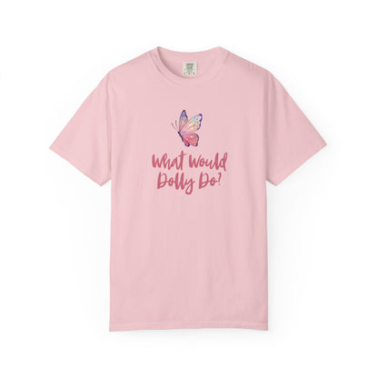 A light pink short-sleeve t-shirt with a pink butterfly graphic and the text 'What Would Dolly Do!' printed on the chest, displayed against a solid white background.