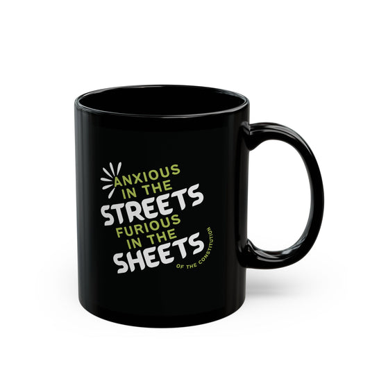 Black ceramic 11 oz coffee or tea mug with "anxious in the streets, furious in the sheets (of the constitution)" lime green and white text