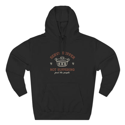 Black hoodie with a white vintage pyrex illustration and dark orange and white text "serve supper, not suffering, feed the people"