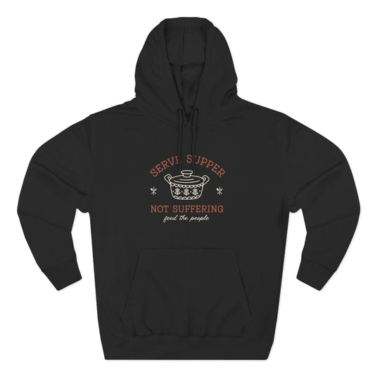 Black hoodie with a white vintage pyrex illustration and dark orange and white text "serve supper, not suffering, feed the people"