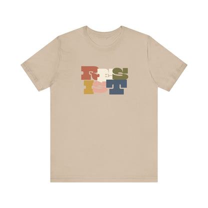 Tan t-shirt with colorful 'RESIST' graphic 