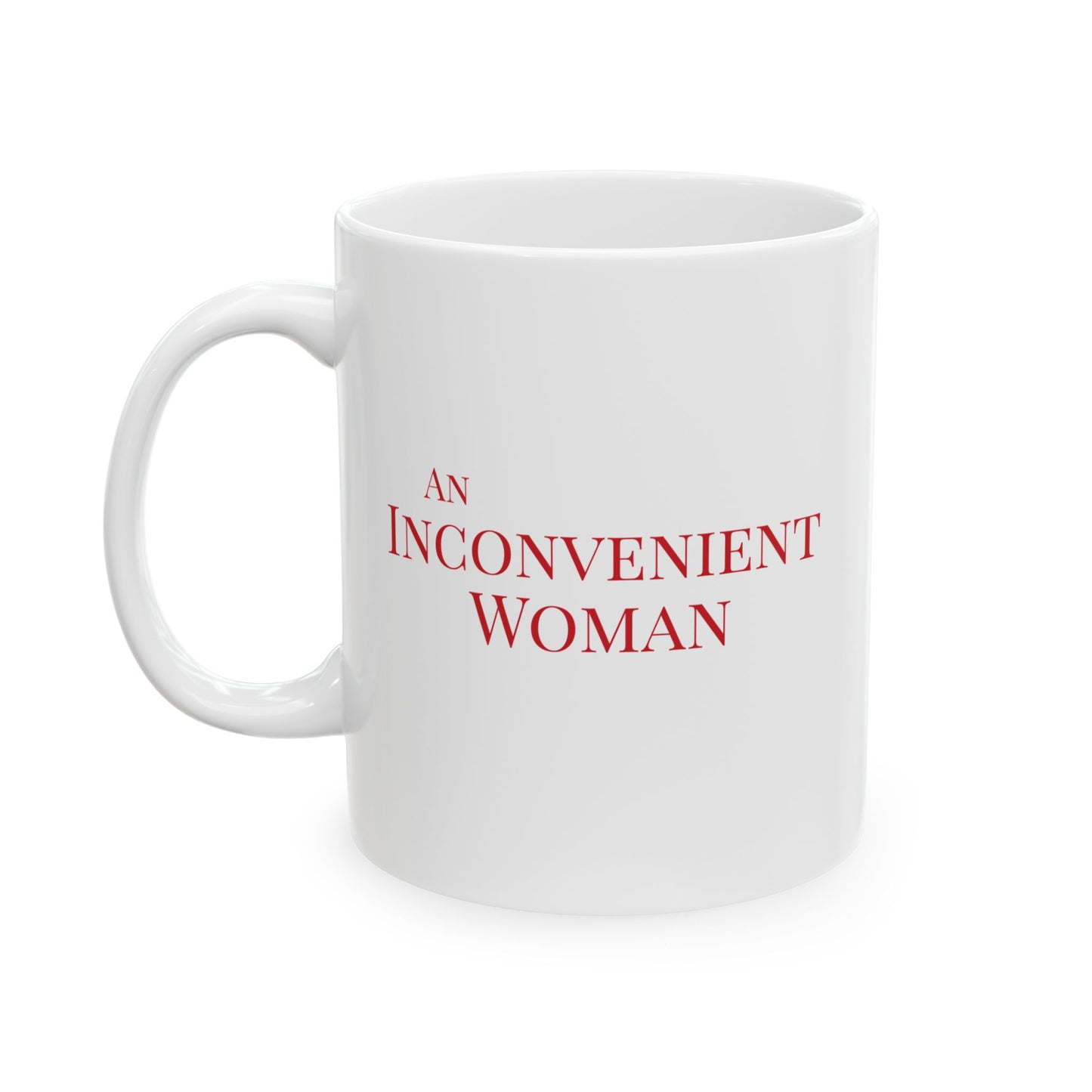 White 11 oz mug with red text 'AN INCONVENIENT WOMAN' 