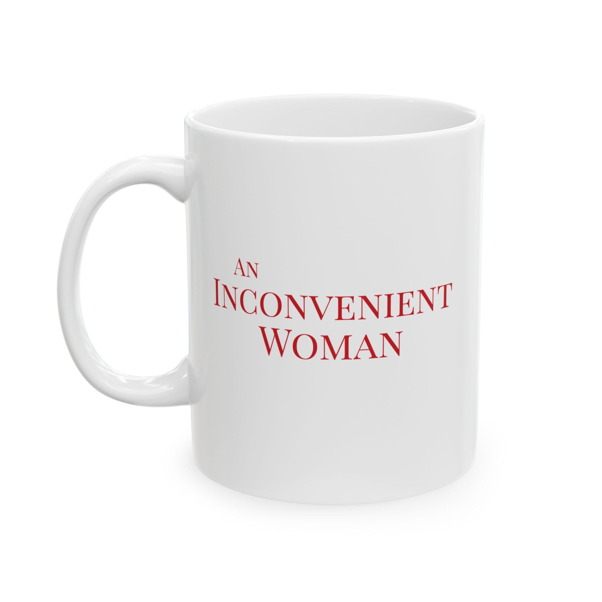 White 11 oz mug with red text 'AN INCONVENIENT WOMAN' 