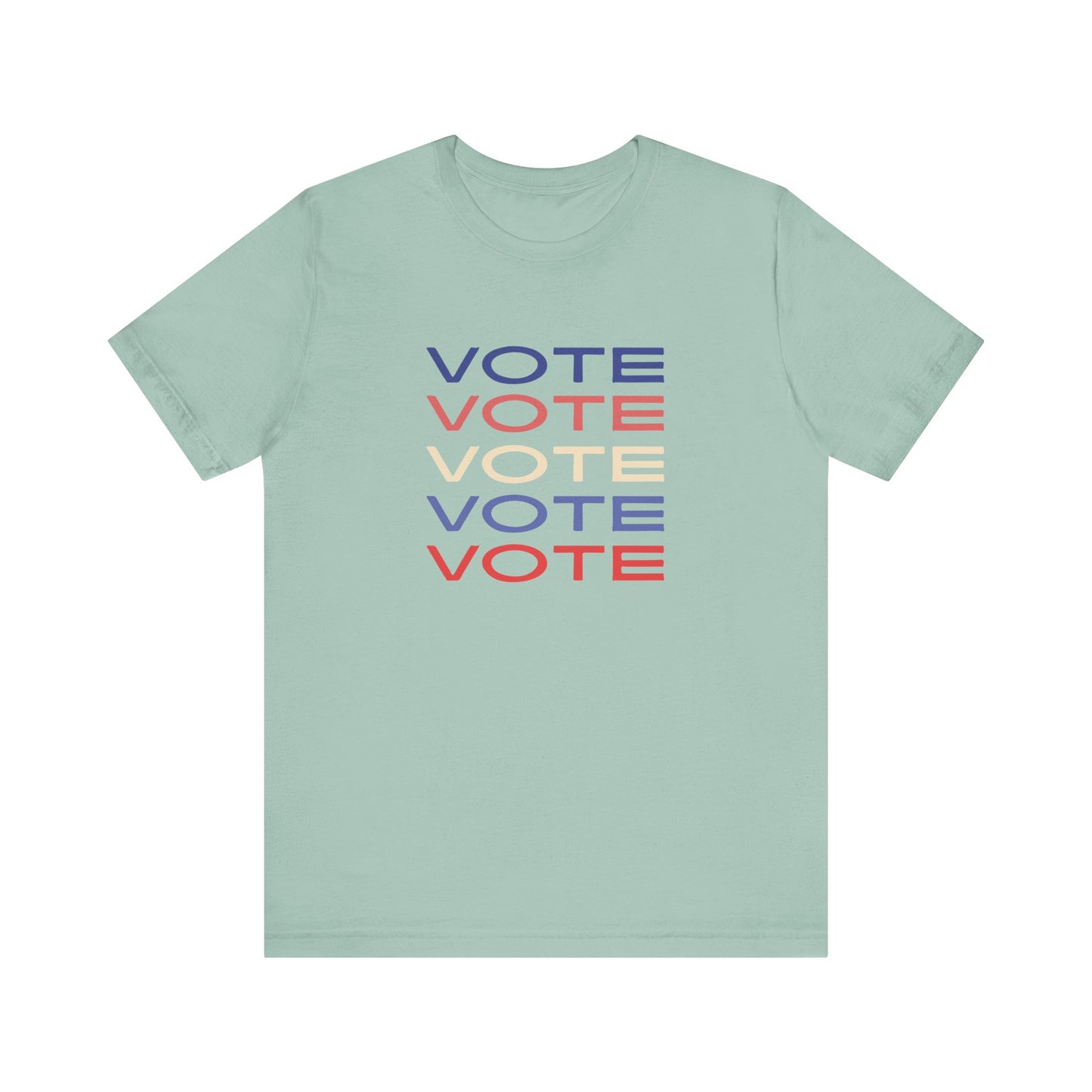 A light green short-sleeve crewneck t-shirt featuring a stacked graphic print of the word 'VOTE' in blue, red, and cream on the chest.