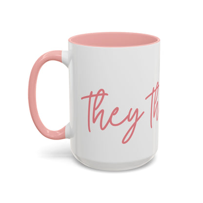 White ceramic 15 oz coffee or tea mug with pink interior and handle, featuring the text "they the people" in pink wraparound