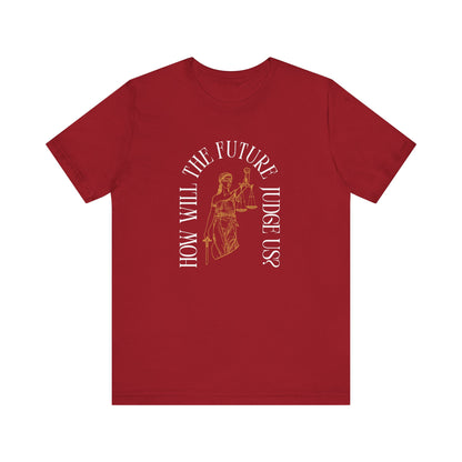 Red t-shirt with sketch of lady justice and words in white arched around it "how will the future judge us?" 
