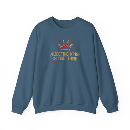 Indigo blue sweatshirt with gold sketch graphic of a crown with a red X over it and gold text "REJECTING KINGS IS OUR THING"