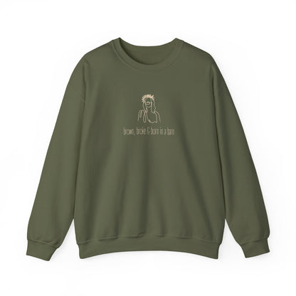 Military green unisex crewneck sweatshirt with a sketch graphic of Jesus and "brown, broke & born in a barn" cream text