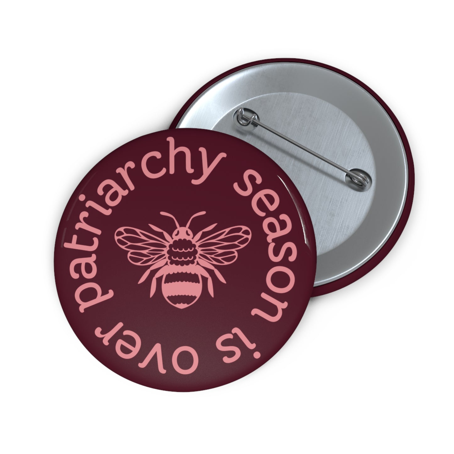 Maroon pin button with pink "patriarchy season is over" text circling around a queen bee graphic 