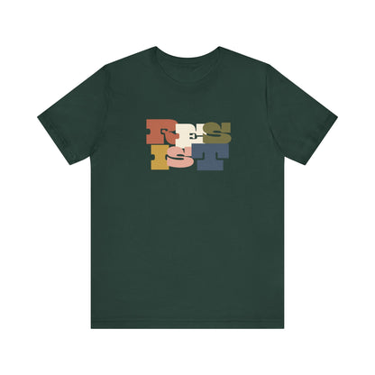 Dark green t-shirt with colorful 'RESIST' graphic 
